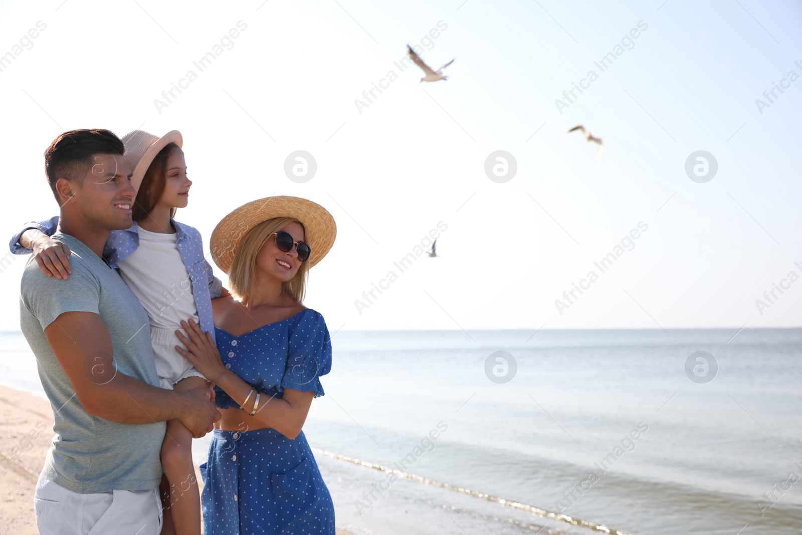 Photo of Happy family at beach on sunny summer day