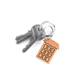 House keys with trinket on white background, top view