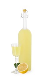 Tasty limoncello liqueur, half of lemon and green leaf isolated on white