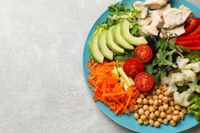 Photo of Balanced diet and healthy foods. Plate with different delicious products on grey table, top view. Space for text