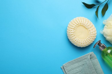 Flat lay composition with bath sponge on light blue background. Space for text