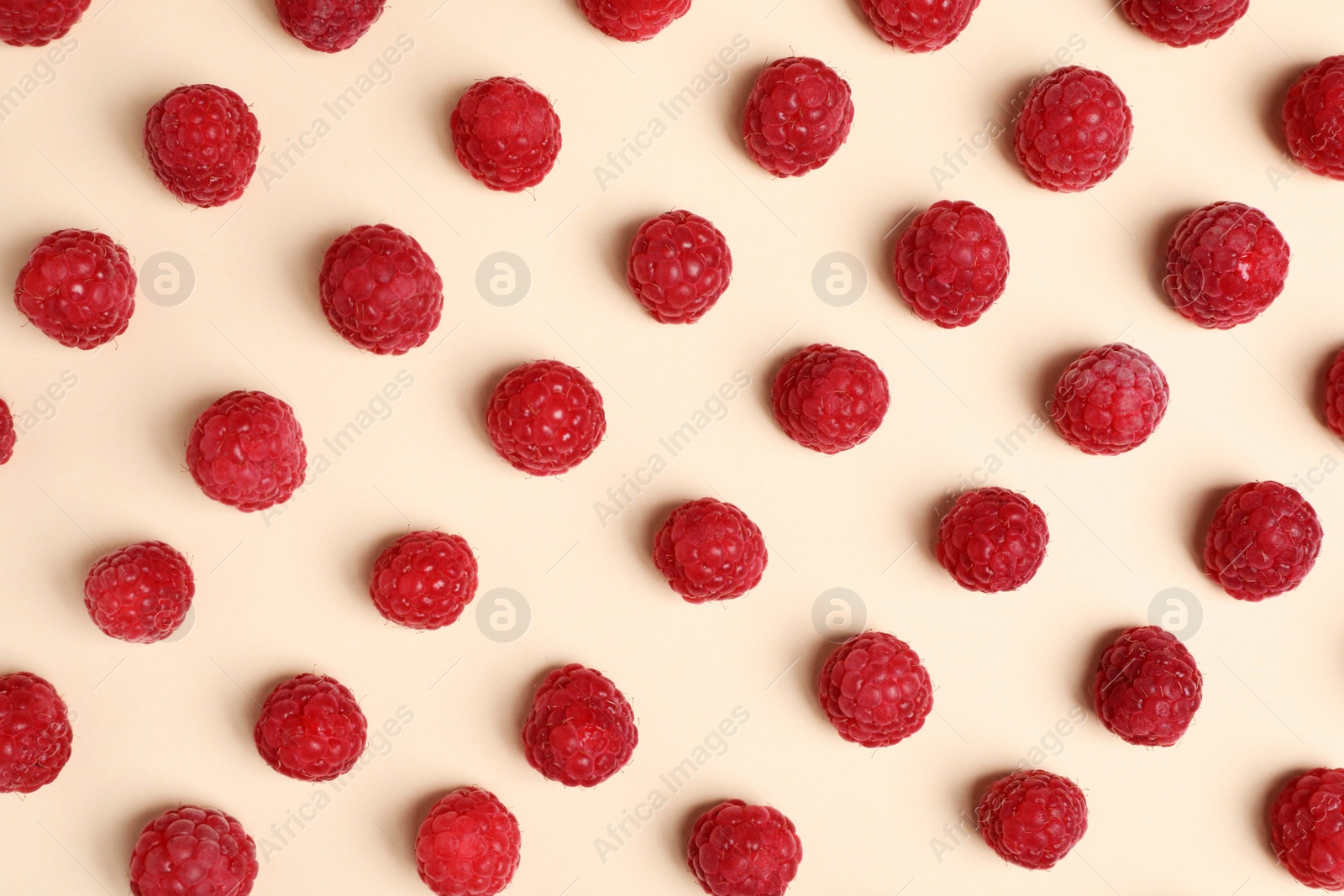 Photo of Flat lay composition with ripe aromatic raspberries on color background