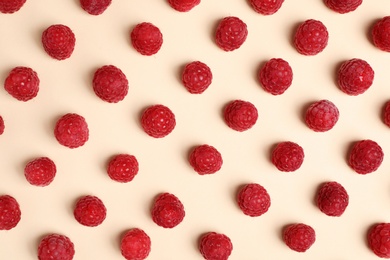 Flat lay composition with ripe aromatic raspberries on color background