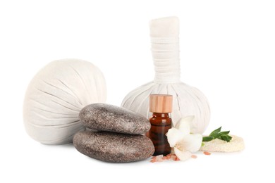 Photo of Herbal massage bags and other spa products on white background