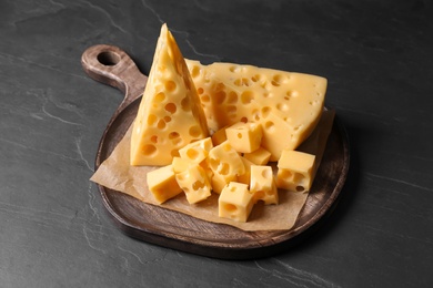 Photo of Tasty fresh cheese on dark grey table