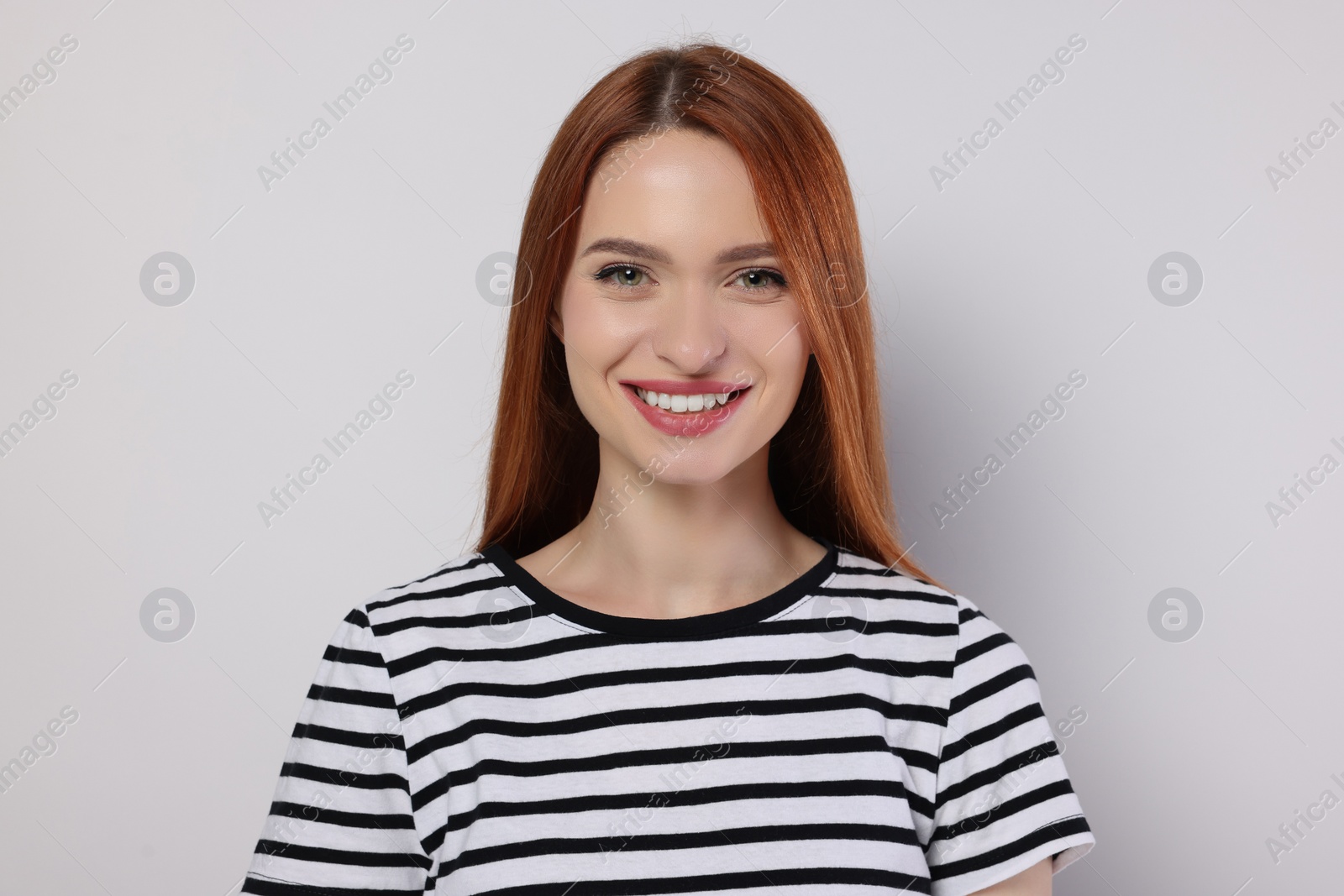 Photo of Portrait of beautiful young woman on light gray background