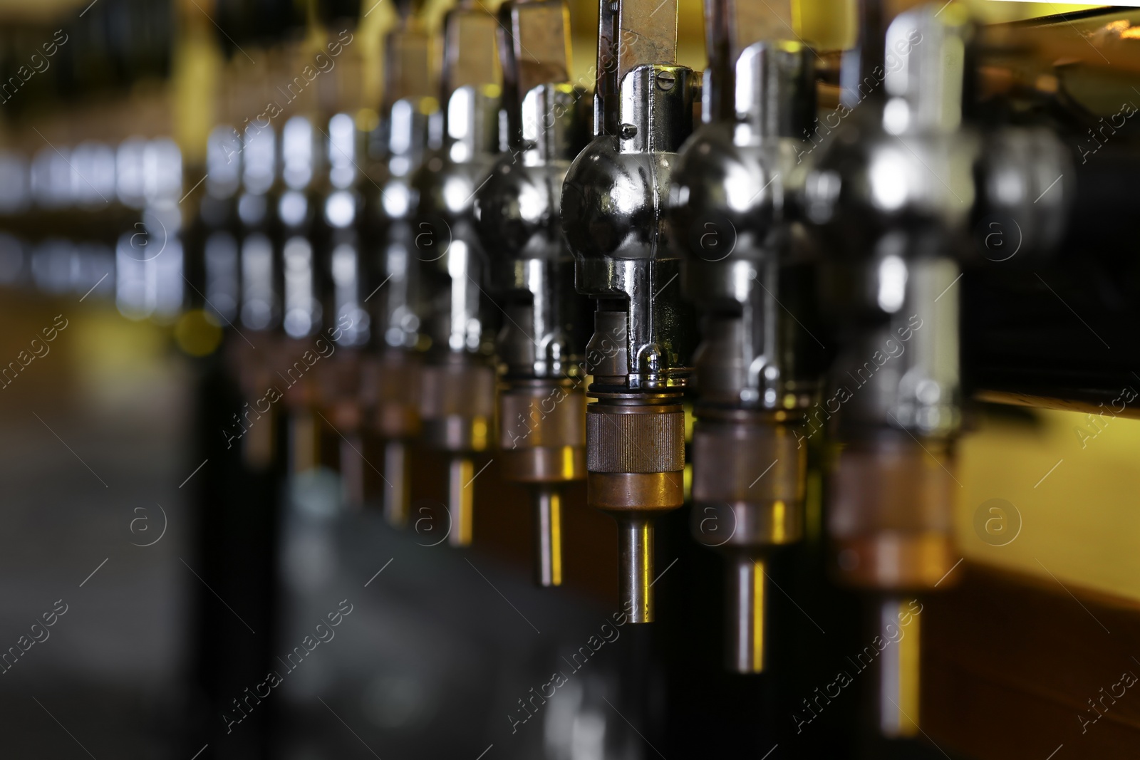 Photo of New modern beer taps in pub, closeup. Professional bar equipment