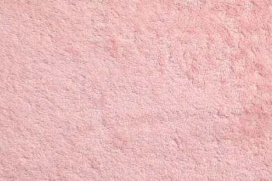 Photo of Soft pink towel as background, top view