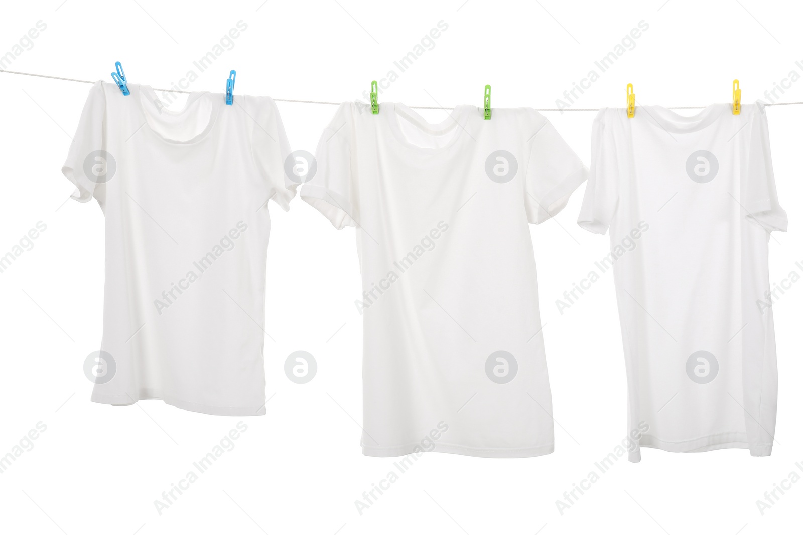 Photo of Many t-shirts drying on washing line isolated on white