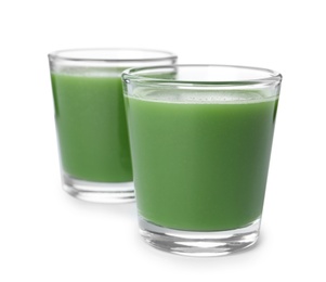Photo of Fresh wheat grass juice in glasses on white background