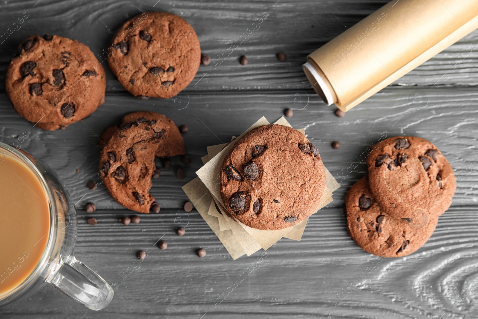 Photo of Flat lay composition with tasty chocolate chip cookies on wooden background