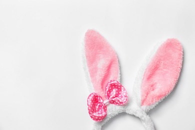 Photo of Funny headband with Easter bunny ears on white background, top view