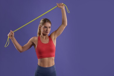 Athletic woman exercising with elastic resistance band on purple background. Space for text