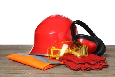 Personal protective equipment on wooden surface against white background