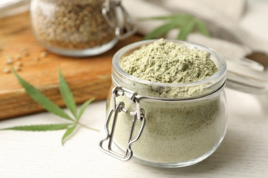 Jar of hemp protein powder on light table, closeup