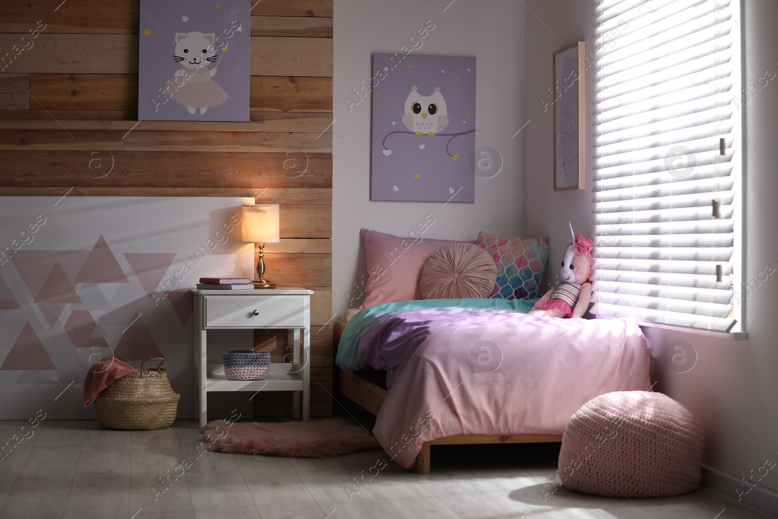 Photo of Bed with beautiful linens in children's room. Modern interior design