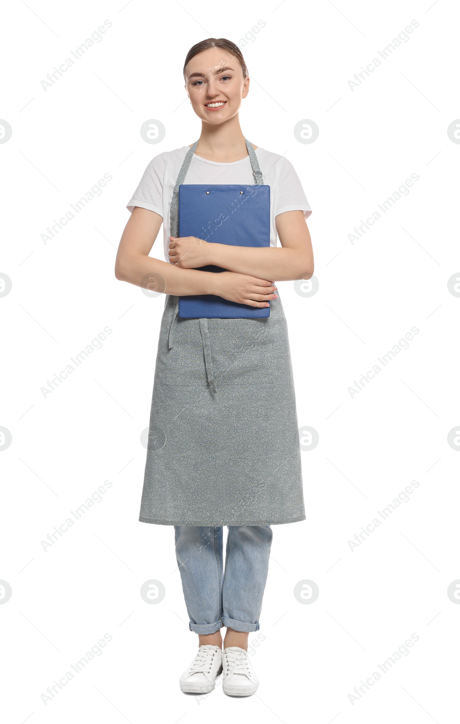 Photo of Beautiful young woman in clean apron with clipboard on white background