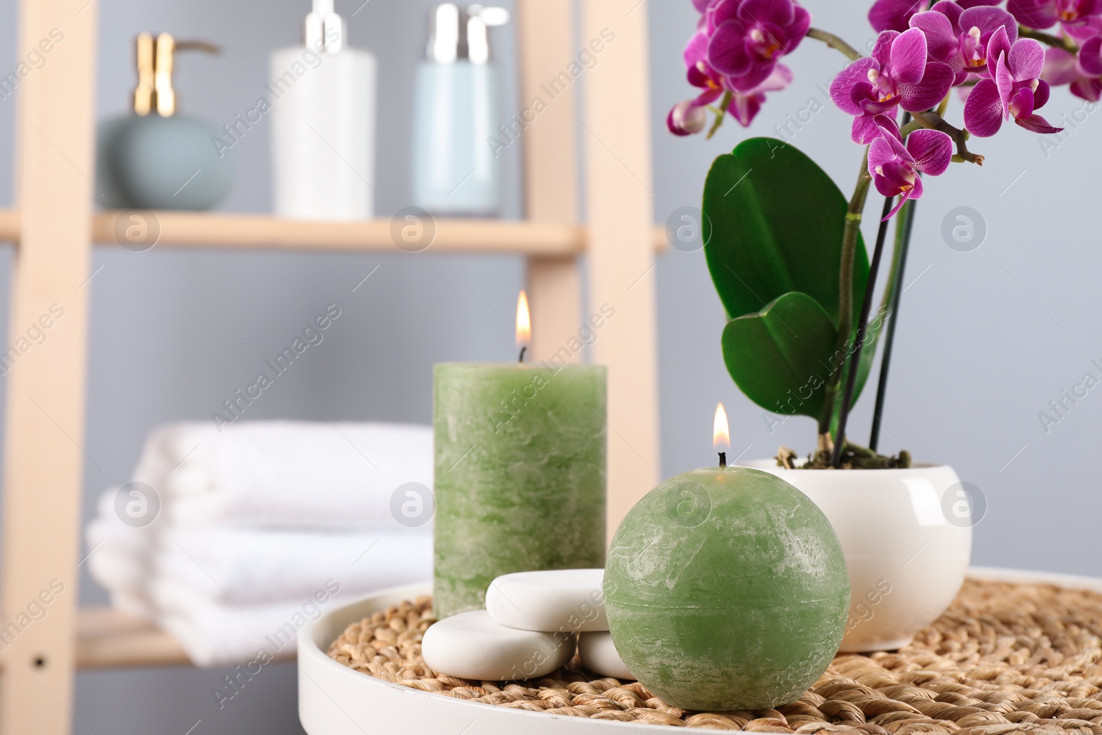 Photo of Spa accessories and blooming orchid on table indoors