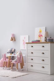Photo of Children's room with modern furniture and pictures. Interior design