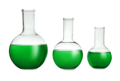Boiling flasks with green liquid isolated on white. Laboratory glassware