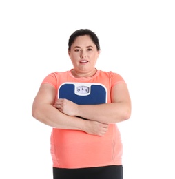 Overweight woman in sportswear with scales on white background