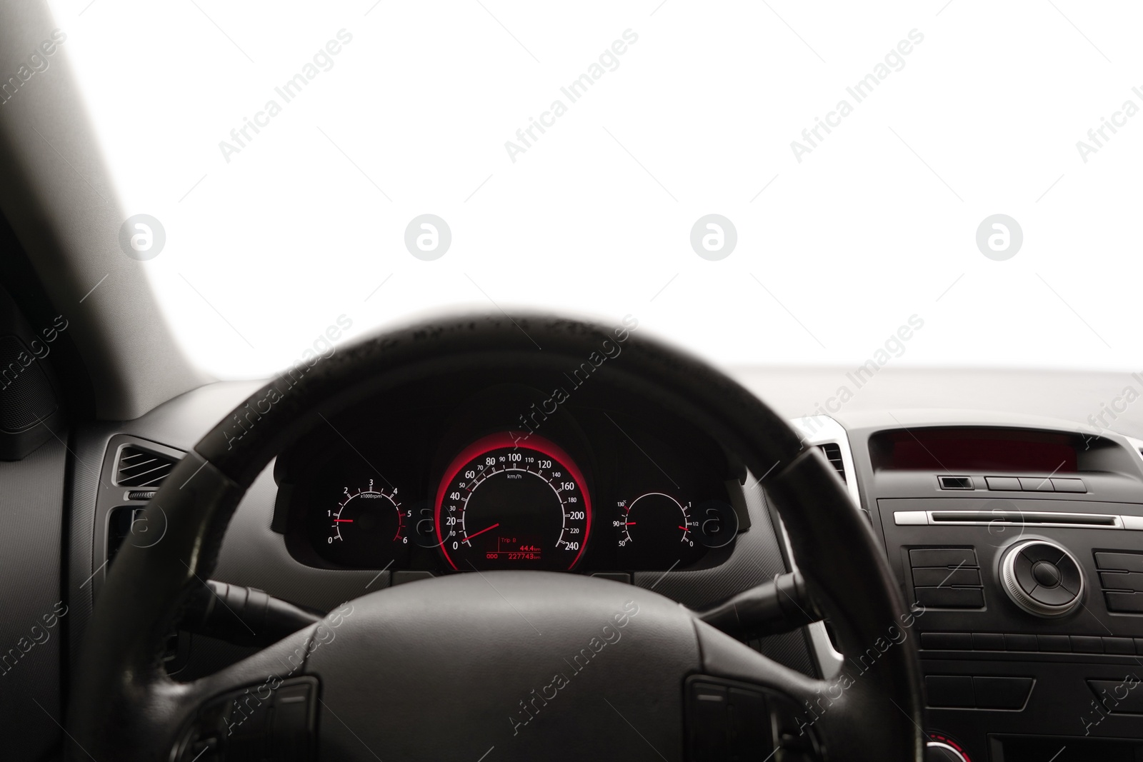 Photo of Speedometer on dashboard and steering wheel inside car