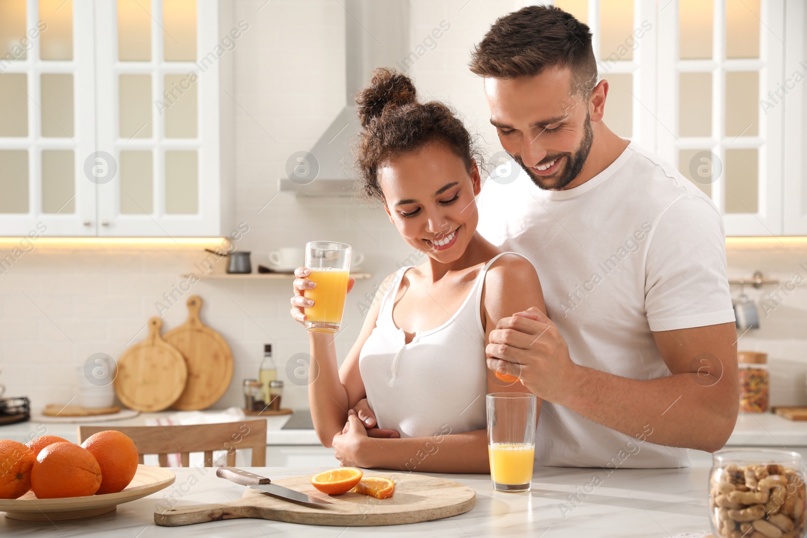 Photo of Lovely couple enjoying time together during breakfast at table in kitchen