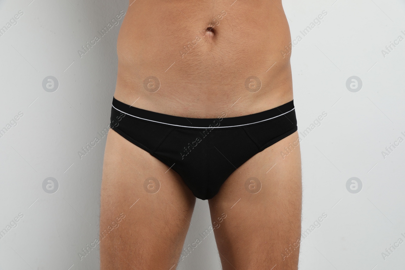 Photo of Man in black underwear on white background, closeup