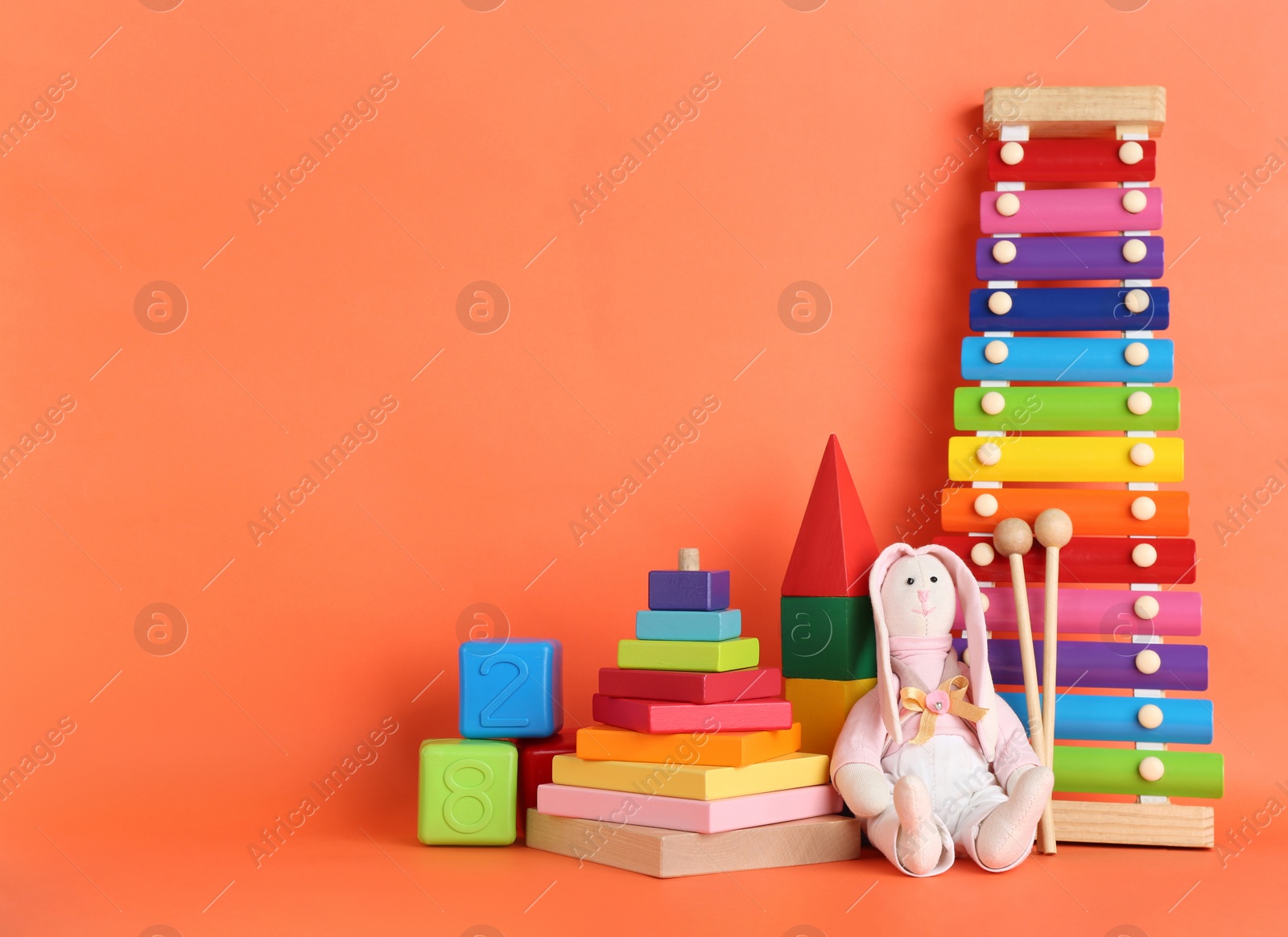 Photo of Set of different toys on orange background. Space for text