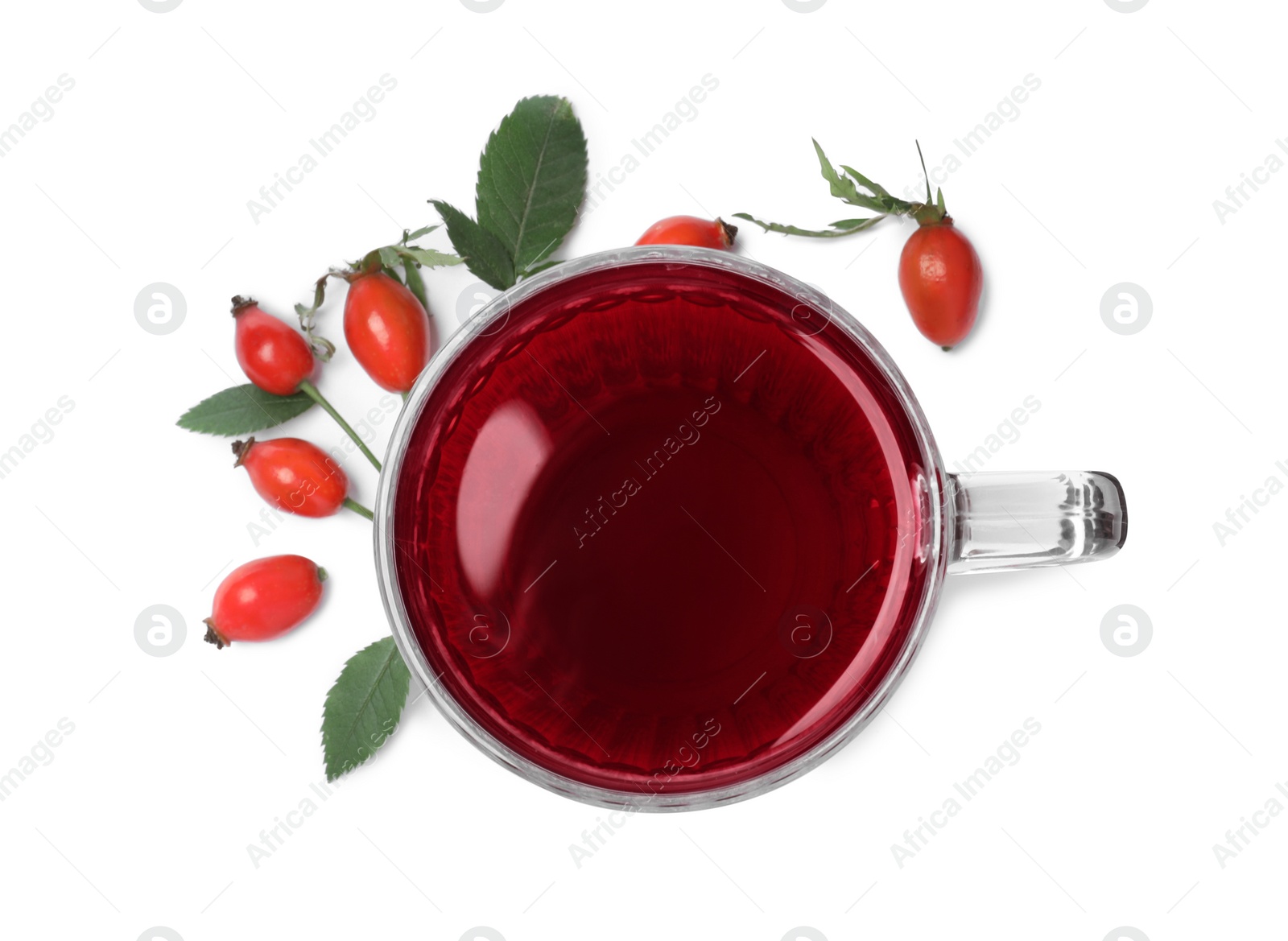 Photo of Aromatic rose hip tea and fresh berries on white background, top view