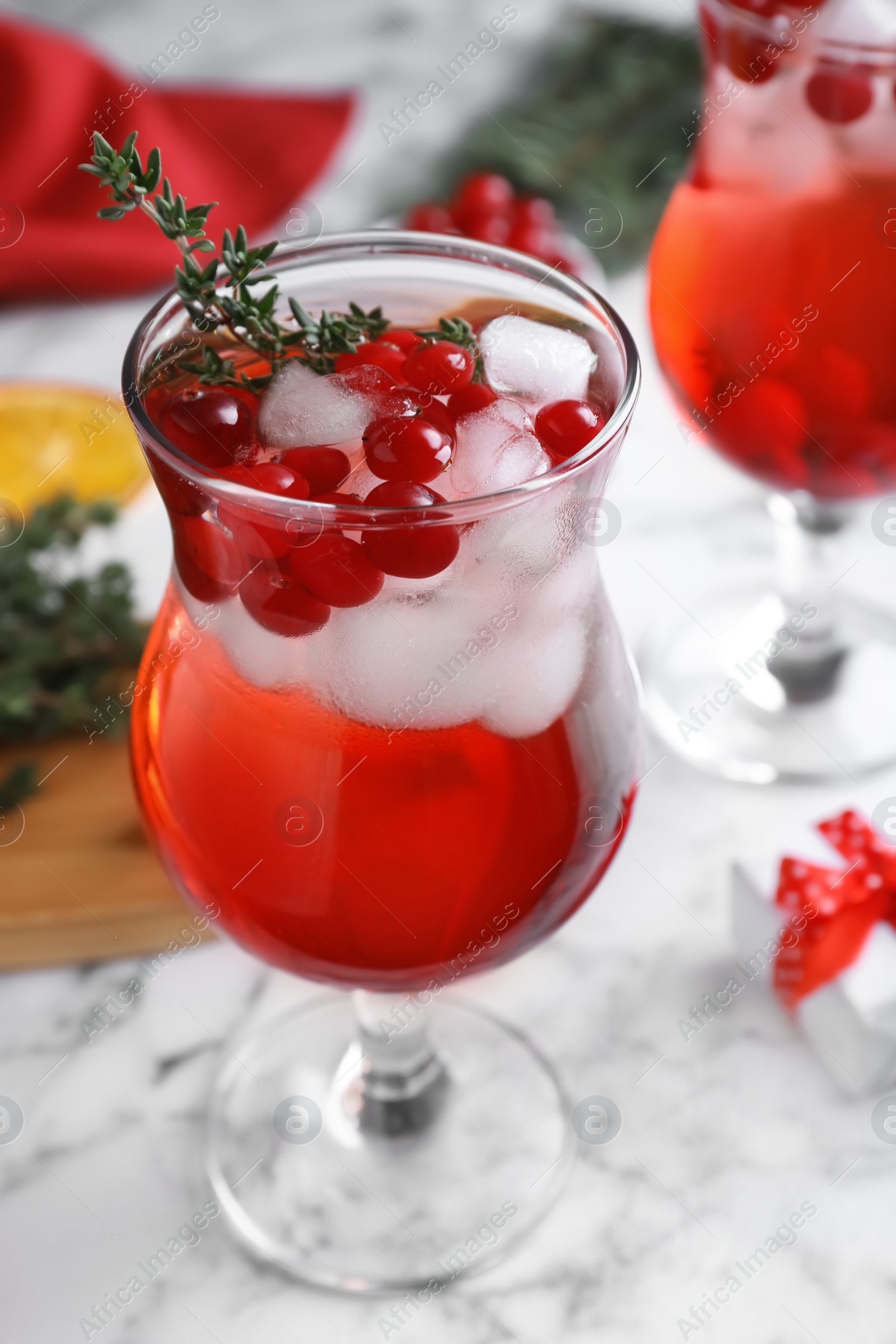 Photo of Delicious Christmas liqueur on white marble table, closeup