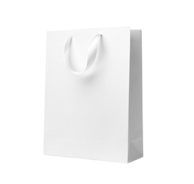 Photo of Paper shopping bag with ribbon handles on white background. Mockup for design