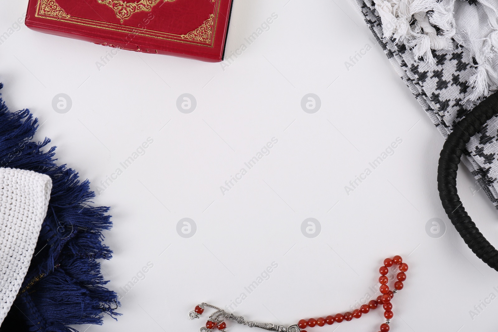 Photo of Flat lay composition with Muslim prayer beads, Quran and space for text on white background