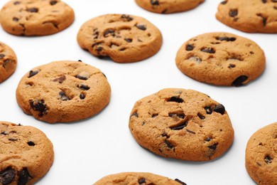 Photo of Many delicious chocolate chip cookies on white background, closeup