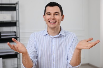 Photo of Man having video chat in office, view from web camera