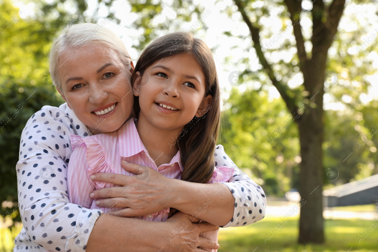 Photo of Mature woman with her little granddaughter in park