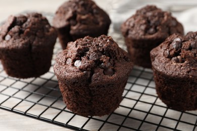 Delicious chocolate muffins on table, closeup view