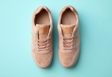 Photo of Pair of stylish shoes on light blue background, top view