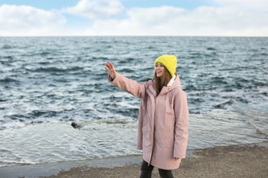 Portrait of beautiful young woman near sea