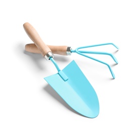 Photo of New rake and trowel on white background. Professional gardening tools