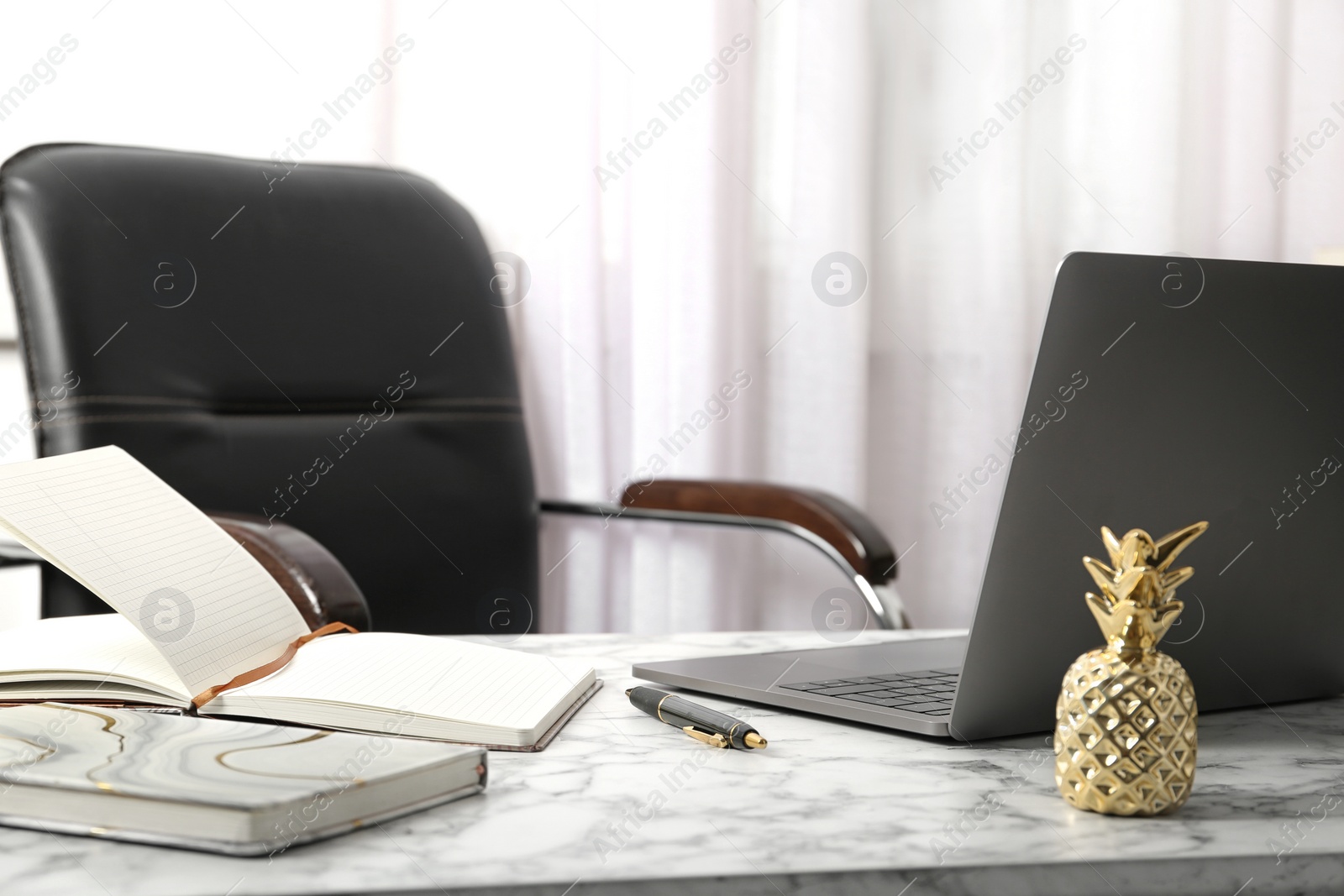 Photo of Stylish workplace with different golden accessories indoors. Idea for interior design