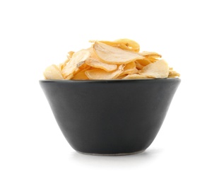 Dried garlic flakes in bowl on white background