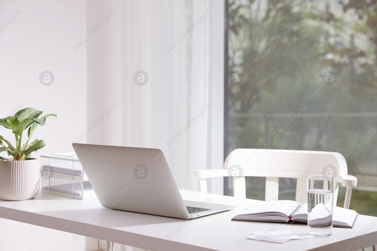 Photo of Comfortable workplace with modern laptop in office