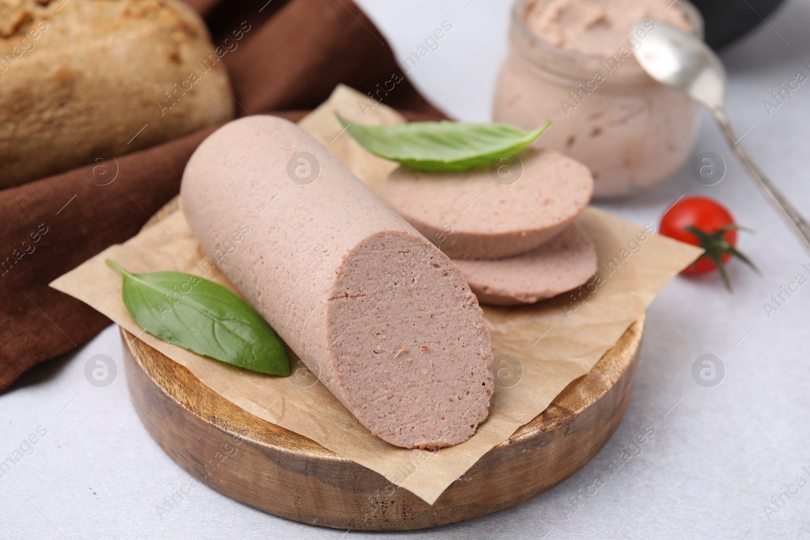 Photo of Delicious liver sausages on light grey table