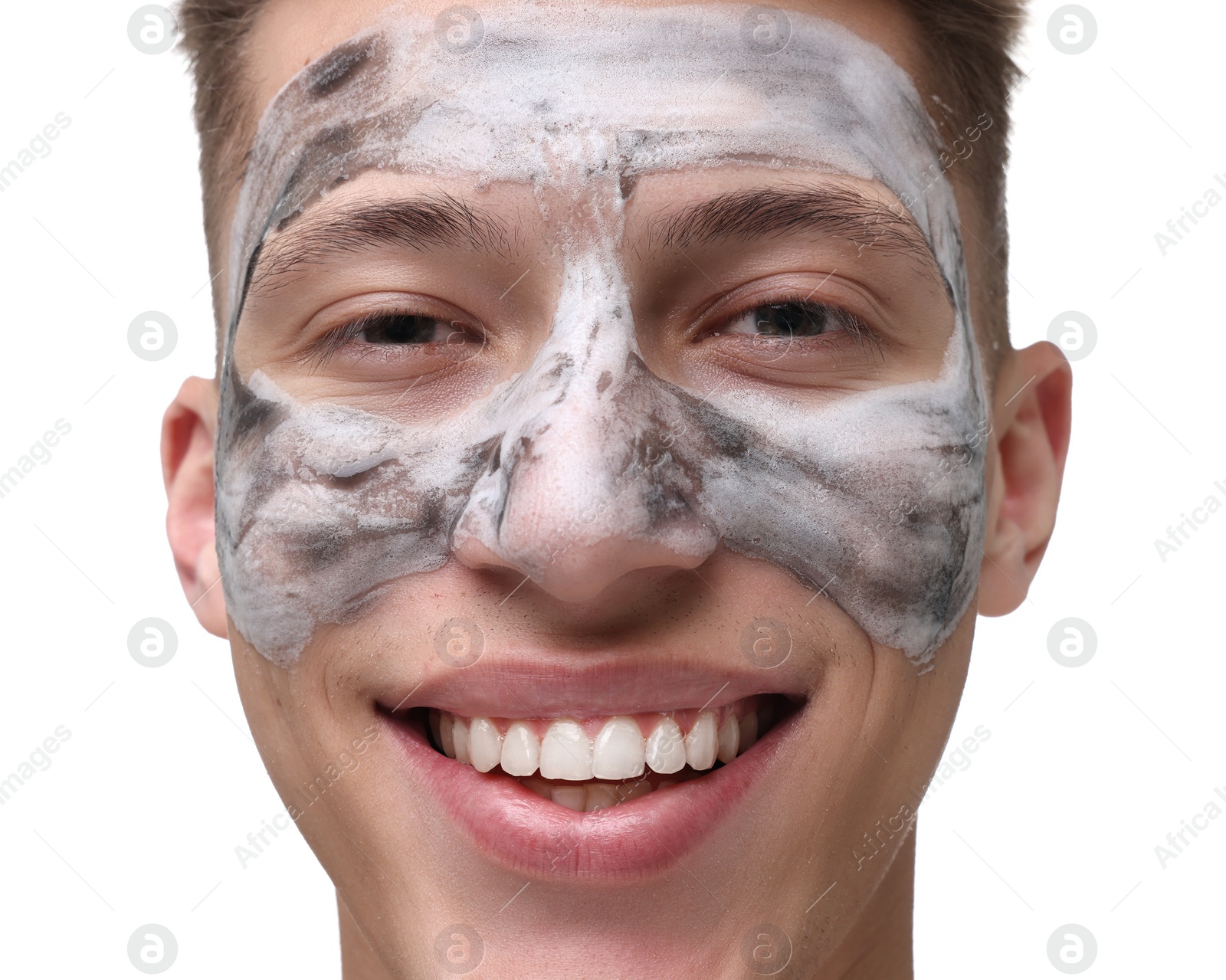 Photo of Handsome man with clay mask on his face against white background, closeup