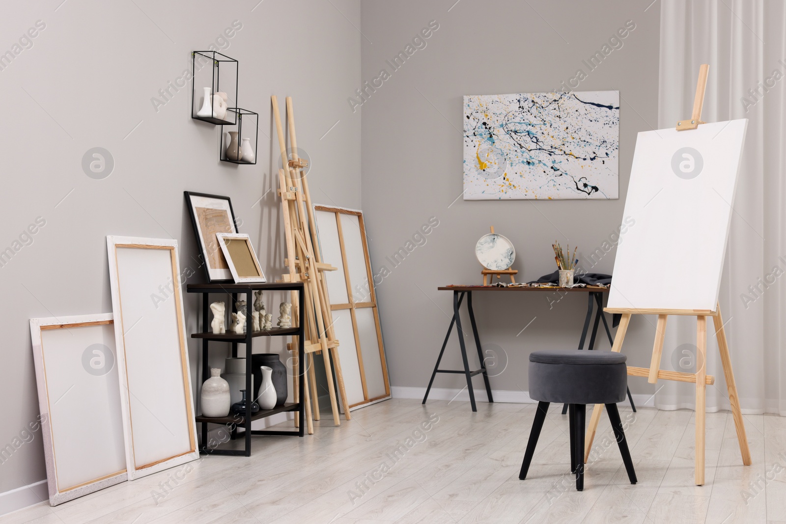 Photo of Artist's studio with easels, canvases and painting supplies