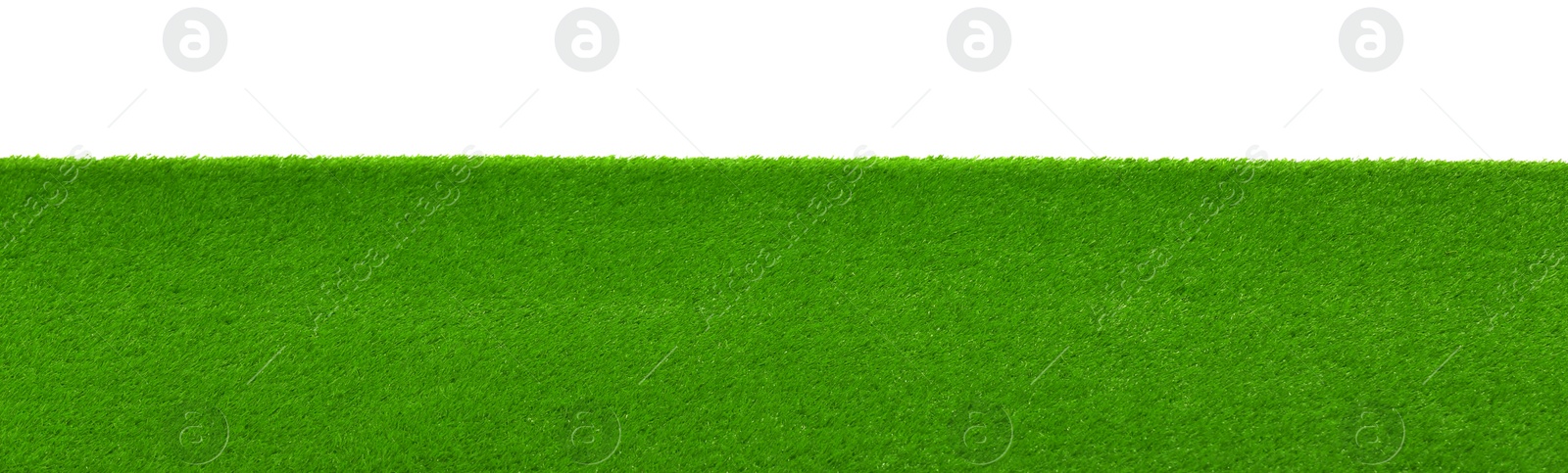 Photo of Green artificial grass surface isolated on white