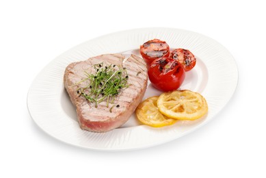 Photo of Delicious tuna steak with tomatoes and lemon isolated on white