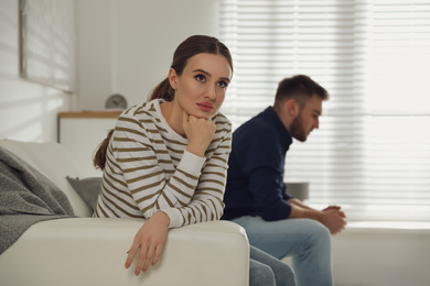 Photo of Young couple quarreling at home. Jealousy in relationship