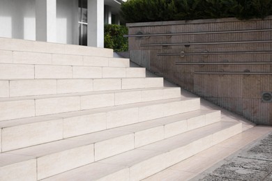 Photo of Outdoor beige stairs with ramp and metal railings